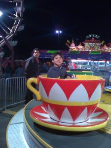 Little boy enjoys mementum at the fair.